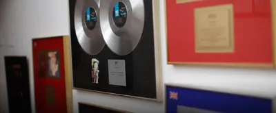 Wall of framed certified discs and other music industry awards