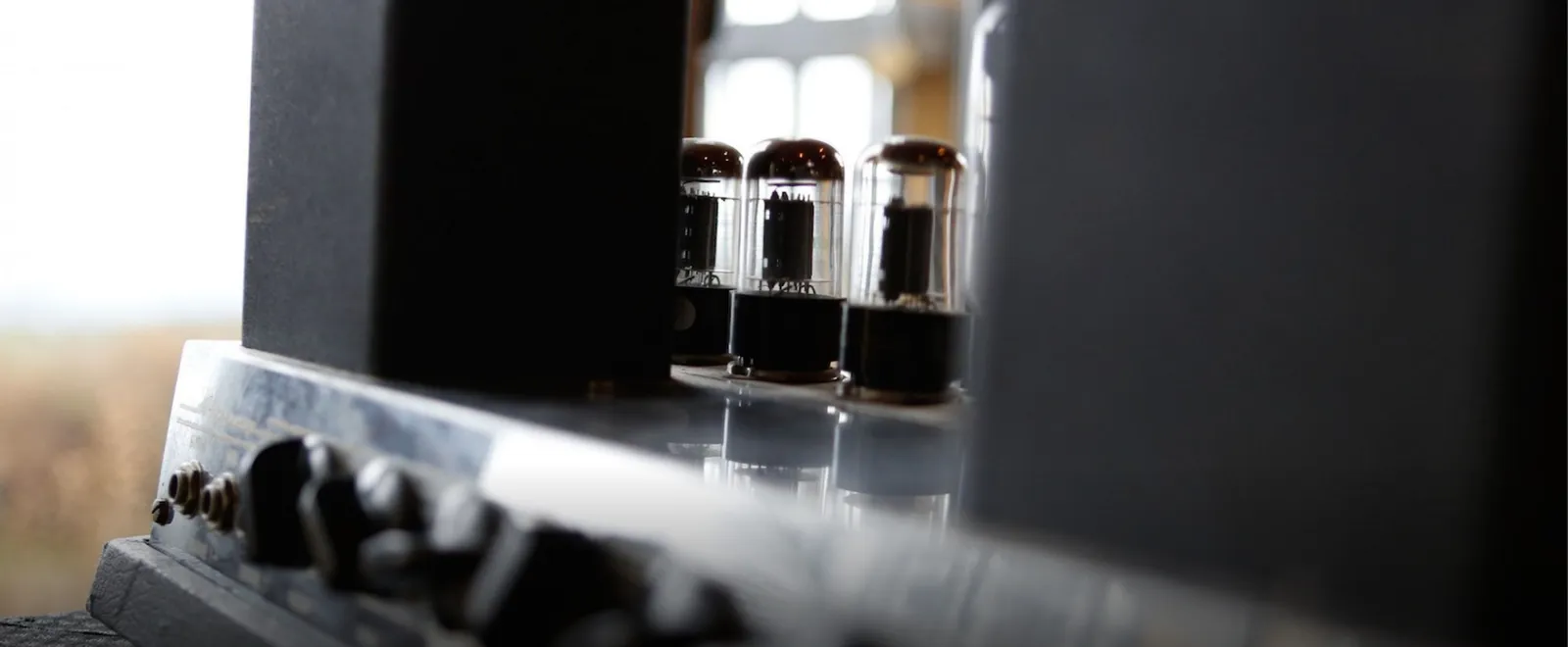 Close-up of the glass valves on a tube amplifier, window light behind