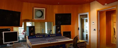 TL Audio VTC desk with nearfield monitors and warm wood-panelled walls